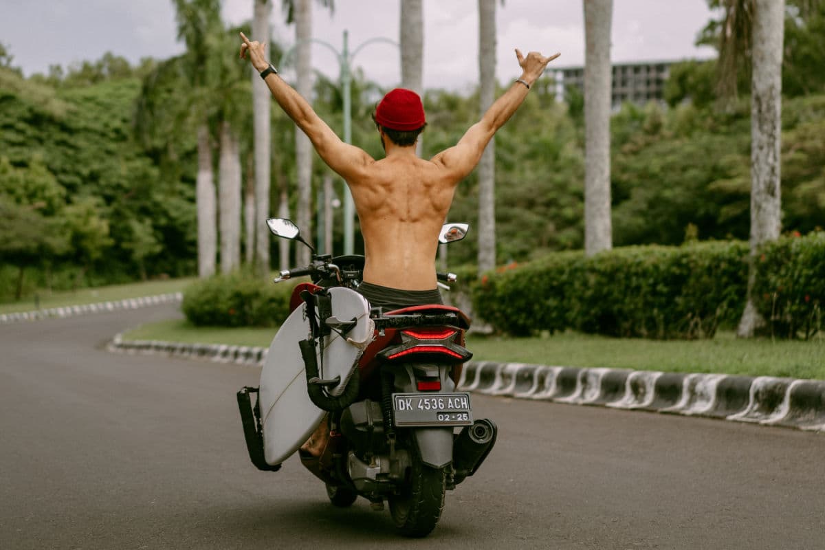 Tourist in Bali riding a bike without a helmet or a shirt
